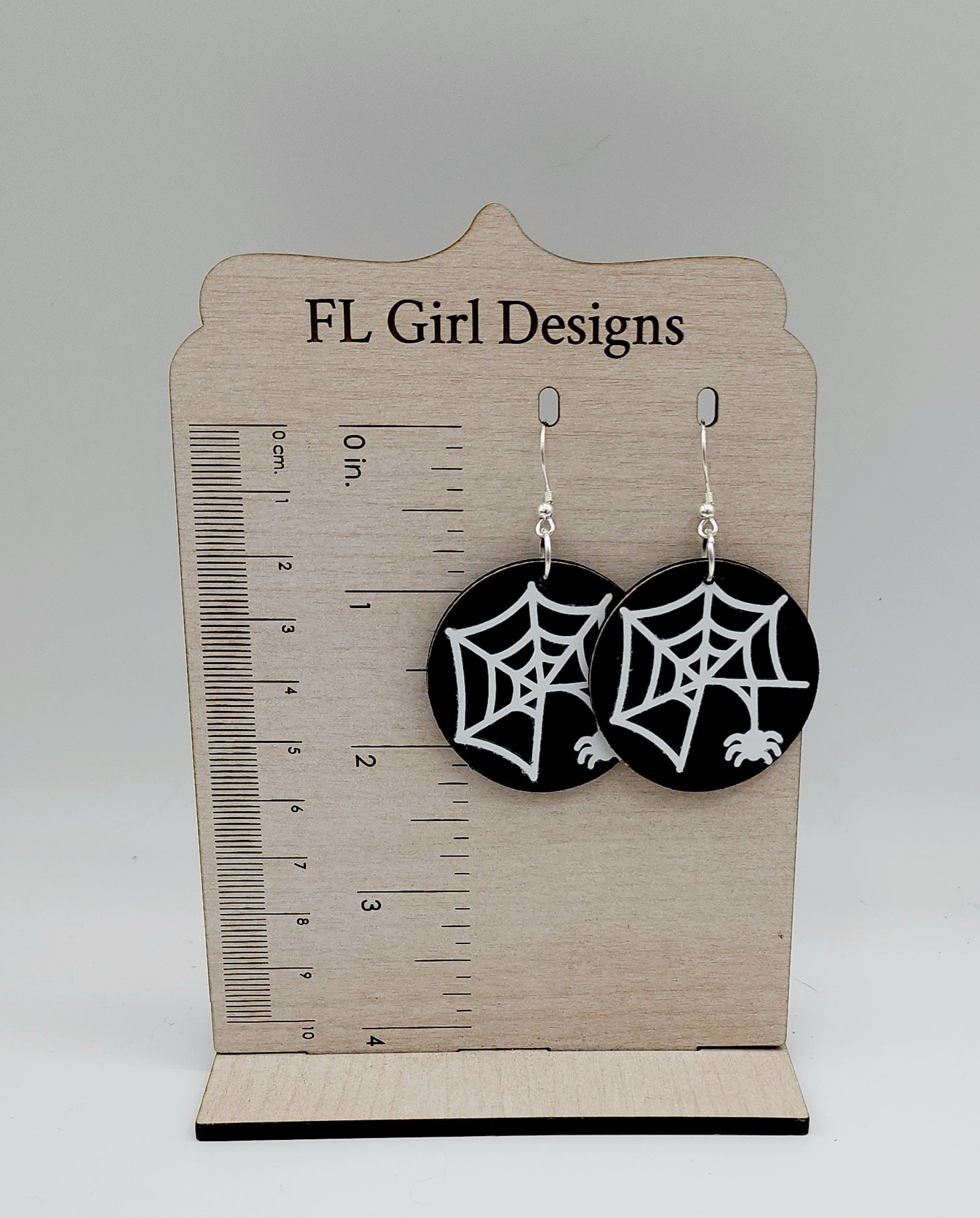 Glow In The Dark Spider and Web on Black Cork Rounds.  Shows how they measure 2.25" with the stainless steel french earring hooks.